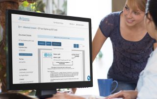 Two women gazing at computer with Florence on it